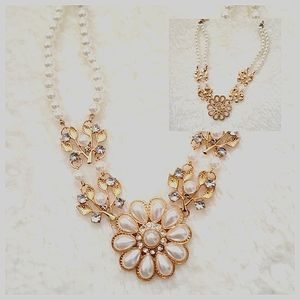 A choker necklace crafted from white pearls and accented with gold hardware